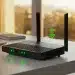 Modern wireless router with LED status lights in a sleek home office environment